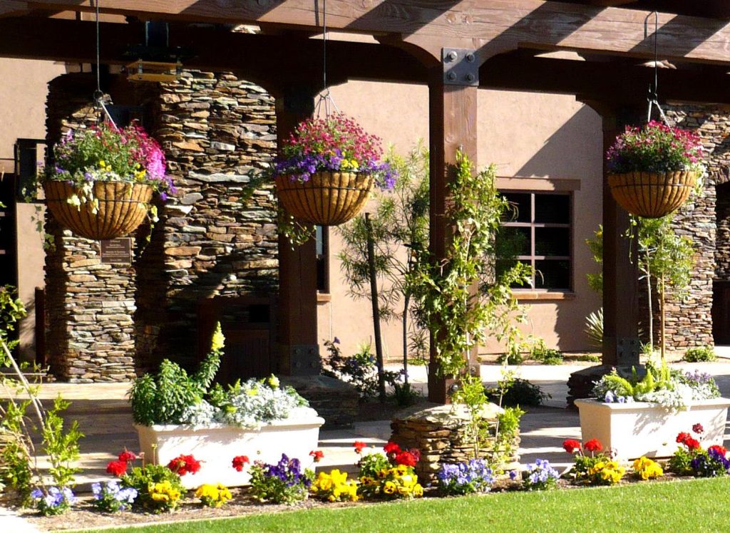 Hanging Baskets, Pots and Beds Create a Living Dividerin a Desert Potted Garden